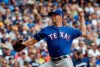 Texas Rangers starting pitcher Mike Minor throws during the first inning of a baseball game against the Milwaukee Brewers Sunday, Aug. 11, 2019, in Milwaukee. (AP Photo/Morry Gash)