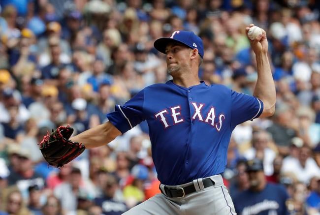 Texas Rangers starting pitcher Mike Minor throws during the first inning of a baseball game against the Milwaukee Brewers Sunday, Aug. 11, 2019, in Milwaukee. (AP Photo/Morry Gash)