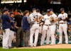 Milwaukee Brewers starting pitcher Adrian Houser is looked at by a trainer during the third inning of a baseball game against the San Diego Padres Wednesday, Sept. 18, 2019, in Milwaukee. (AP Photo/Morry Gash)