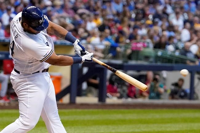 Milwaukee Brewers' Jesus Aguilar hits a double during the fourth inning of a baseball game against the Cincinnati Reds Monday, July 22, 2019, in Milwaukee. (AP Photo/Morry Gash)