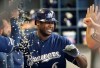 Milwaukee Brewers' Lorenzo Cain is congratulated after hitting a home run during the fourth inning of a baseball game against the San Diego Padres Thursday, Sept. 19, 2019, in Milwaukee. (AP Photo/Morry Gash)