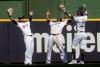 Milwaukee Brewers' Ben Gamel, Lorenzo Cain and Christian Yelich celebrate after a baseball game against the Miami Marlins Thursday, June 6, 2019, in Milwaukee. The Brewers won 5-1. (AP Photo/Morry Gash)