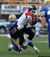 Trevor Hagan/  The Canadian Press archives
Winnipeg's Odell Willis tackles Calgary Stampeders' Henry Burris  during the first half of a game in Winnipeg on July 14.