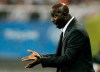 FILE - In this file photo dated Tuesday, Aug. 19, 2008, Nigeria's head coach Samson Siasia directs his players during a men's semifinal soccer match against Belgium at the Beijing 2008 Olympics in Shanghai. Siasia, the coach who led Nigeria to bronze at the 2016 Rio de Janeiro Olympics, has been banned for life by FIFA on Friday Aug. 16, 2019, for receiving bribes to fix soccer matches.(AP Photo/Eugene Hoshiko, FILE)