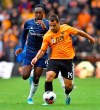 Wolverhampton Wanderers' Jonny, right, and Watford's Danny Welbeck in action during their English Premier League soccer match at Molineux Stadium in Wolverhampton, England, Saturday Sept. 28, 2019. (Dave Howarth/PA via AP)
