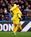 Chelsea's N'Golo Kante, top, celebrates scoring his side's first goal of the game against Crystal Palace, with teammate Ross Barkley, during their English Premier League soccer match at Selhurst Park in London, Sunday Dec. 30, 2018. (John Walton/PA via AP)