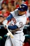 Houston Astros' Michael Brantley hits a RBI-single against the Washington Nationals during the third inning of Game 3 of the baseball World Series Friday, Oct. 25, 2019, in Washington. (AP Photo/Patrick Semansky)
