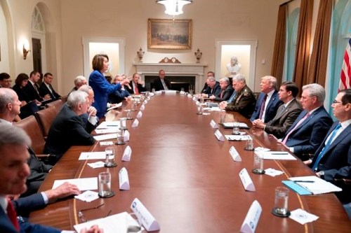In this photo released by the White House, President Donald Trump, center right, meets with House Speaker Nancy Pelosi, standing left, Congressional leadership and others, Wednesday, Oct. 16, 2019, in the Cabinet Room of the White House in Washington. (Official White House Photo by Shealah Craighead via AP)