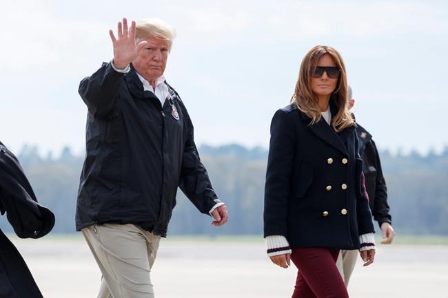 FILE - In this March 8, 2019 file photo, President Donald Trump and first lady Melania Trump walk from Marine One to board Air Force One at Lawson Army Airfield, Fort Benning, Ga., en route Palm Beach International Airport in West Palm Beach, Fla., after visiting Lee County, Ala., where tornados killed 23 people. Trump has had it with the #fakeMelania conspiracy theories circulating on social media. Trump is claiming that photos of his wife were altered to make it appear that a look-alike accompanied him to Alabama last week. (AP Photo/Carolyn Kaster)