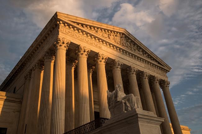 FILE - In this Oct. 10, 2017, file photo, the Supreme Court in Washington, at sunset. The Supreme Court is upholding an Indiana law that requires abortion providers to dispose of aborted fetuses in the same way as human remains. But the justices are staying out of the debate over a broader provision that would prevent a woman in Indiana from having an abortion based on gender, race or disability. (AP Photo/J. Scott Applewhite, File)