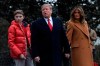 In this Feb. 1, 2019, photo, President Donald Trump, center, first lady Melania Trump, right, and their son Barron Trump, left, walk out of the White House and head to Marine One on the South Lawn of White House in Washington. A woman whose life sentence for drug offenses was commuted by President Donald Trump and a Delaware student allegedly bullied because his last name is Trump are among guests who will sit with first lady Melania Trump for the State of the Union address. (AP Photo/Susan Walsh)