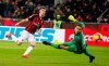 AC Milan's Krzysztof Piatek, left, scores his side's opening goal during an Italian Cup quarter-final soccer match between AC Milan and Napoli at the San Siro stadium, in Milan, Italy, Tuesday, Jan. 29, 2019. (AP Photo/Antonio Calanni)