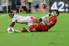 Roma's Lorenzo Pellegrini, right, challenges for the ball with Genoa's Christian Kouame during the Serie A soccer match between Roma and Genoa at the Rome Olympic stadium, Sunday, Aug. 25, 2019. (AP Photo/Alessandra Tarantino)