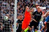 Brighton's Glenn Murray, center right, heads the ball past Manchester City goalkeeper Ederson, center, to score the opening goal during the English Premier League soccer match between Brighton and Manchester City at the AMEX Stadium in Brighton, England, Sunday, May 12, 2019. (AP Photo/Frank Augstein)