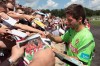 Portugal's Joao Moutinho signs autographs for fans during a training prior to their Euro 2012 soccer semifinal match, in Opalenica, Poland, Saturday, June 23, 2012. (AP Photo/Armando Franca)
