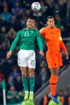 Northern Ireland's Josh Magennis jumps for the ball with Netherlands' Virgil Van Dijk, right, during the Euro 2020 group C qualifying soccer match between Northern Ireland and the Netherlands at Windsor Park, Belfast, Northern Ireland, Saturday, Nov. 16, 2019. (AP Photo/Peter Morrison)