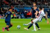 PSG's Angel Di Maria shoots the ball between Real Madrid's Gareth Bale and Eder Militao, left, during the Champions League group A soccer match between PSG and Real Madrid at the Parc des Princes stadium in Paris, Wednesday, Sept. 18, 2019. (AP Photo/Michel Euler)