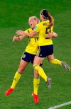 Sweden's Stina Blackstenius celebrates with Kosovare Asllani, right, after scoring the opening goal during the Women's World Cup round of 16 soccer match between Sweden and Canada at the Parc des Princes in Paris, France, Monday, June 24, 2019. (AP Photo/Michel Euler)