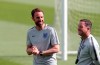 England manager Gareth Southgate, left, smiles during a a training session at their training ground in Guimaraes, Portugal, Saturday, June 8, 2019. England will play Switzerland in the UEFA Nations League third place soccer match Sunday. (AP Photo/Luis Vieira)