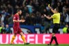 Referee Damir Skomina shows a yellow card to Roma midfielder Alessandro Florenzi during the Champions League round of 16, 2nd leg, soccer match between FC Porto and AS Roma at the Dragao stadium in Porto, Portugal, Wednesday, March 6, 2019. (AP Photo/Luis Vieira)