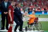 UEFA President Aleksander Ceferin and Ali Turganbekov, from Kazakhstan, right, hand the trophy to Liverpool's team captain Jordan Henderson after Liverpool won the UEFA Super Cup soccer match between Liverpool and Chelsea, in Besiktas Park, in Istanbul, Thursday, Aug. 15, 2019. Liverpool won 5-4 in a penalty shootout after the game ended tied 2-2. (AP Photo/Thanassis Stavrakis)