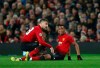 Manchester United's Luke Shaw, left, speaks to Manchester United's Anthony Martial who is injured during the Champions League round of 16 soccer match between Manchester United and Paris Saint Germain at Old Trafford stadium in Manchester, England, Tuesday, Feb. 12,2019.(AP Photo/Dave Thompson)