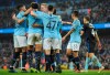 Manchester City's Riyad Mahrez , left, with teammates Kyle Walker, Phil Foden, and Kevin De Bruyne all celebrate after Rotherham's Semi Ajayi scored an own goal during the English FA Cup third round soccer match between Manchester City and Rotherham United at Etihad stadium in Manchester, England, Sunday, Jan. 6, 2019. (AP Photo/Rui Vieira)