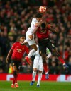 Manchester United's Paul Pogba, right is fouled as he leaps for the ball by Paris Saint Germain's Marcos Marquinhos during the Champions League round of 16 soccer match between Manchester United and Paris Saint Germain at Old Trafford stadium in Manchester, England, Tuesday, Feb. 12,2019.(AP Photo/Dave Thompson)