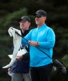 David Duval of the United States cleans one of his clubs as he wait to play on the 5th tee during the first round of the British Open Golf Championships at Royal Portrush in Northern Ireland, Thursday, July 18, 2019.(AP Photo/Jon Super)
