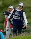 England's Lee Westwood with his caddie and girlfriend Helen Storey walk to the 5th green during the second round of the British Open Golf Championships at Royal Portrush in Northern Ireland, Friday, July 19, 2019.(AP Photo/Matt Dunham)