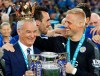 FILE - In this May 7, 2016 file photo, Leicester's team manager Claudio Ranieri gets a crown by Leicester's goalkeeper Kasper Schmeichel as they lift the trophy as Leicester City celebrate becoming the English Premier League soccer champions at King Power stadium in Leicester, England. Claudio Ranieri loves a challenge and his latest job at Sampdoria will be anything but straightforward. (AP Photo/Matt Dunham)
