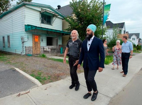 NDP Leader Jagmeet Singh, joined by area residents, tours a neighbourhood damaged by recent flooding during a campaign stop in Gatineau, Que. on Sunday, Sept. 22. 2019. THE CANADIAN PRESS/Andrew Vaughan