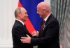 Russian President Vladimir Putin shakes hands with FIFA President Gianni Infantino during an awarding ceremony in the Kremlin in Moscow, Russia, Thursday, May 23, 2019. Putin awarded FIFA President Gianni Infantino with the Order of Friendship and praised the World Cup that Russia hosted last year as the best ever. (Evgenia Novozhenina/Pool Photo via AP)