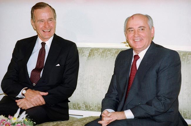 FILE - In this file photo taken on Tuesday, Oct. 29, 1991, U.S. President George H. Bush, left, and Soviet President Mikhail Gorbachev sit together at the Soviet Embassy after meeting in Madrid, Spain. Former Soviet premier Mikhail Gorbachev expressed his