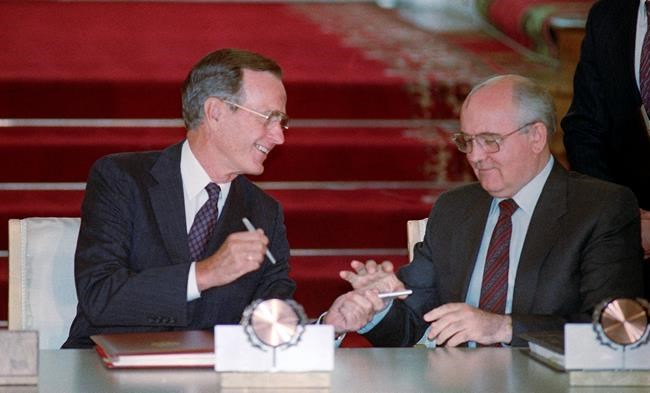 FILE - In this file photo taken Wednesday, Aug. 1, 1991, U.S. President George H. Bush and Soviet President Mikhail Gorbachev exchange pens after signing the START arms reduction treaty in the Kremlin, Moscow. Former Soviet premier Mikhail Gorbachev expressed his