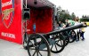 A boy poses for photographs at the Arsenal soccer team booth at the fan area in central Baku, Azerbaijan Tuesday, May 28, 2019. Supporters were arriving in the Azerbaijan capital ahead of Wednesday's Europa League final between English teams Arsenal and Chelsea. (AP Photo/Darko Bandic)