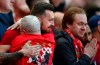 Liverpool supporters celebrate after Brighton scored against Manchester city during the English Premier League soccer match between Liverpool and Wolverhampton Wanderers at the Anfield stadium in Liverpool, England, Sunday, May 12, 2019. (AP Photo/Dave Thompson)