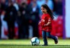 Makka, age 5, the daughter of Liverpool's Mohamed Salah, not pictured, kicks the ball at the end of the English Premier League soccer match between Liverpool and Wolverhampton Wanderers at the Anfield stadium in Liverpool, England, Sunday, May 12, 2019. Despite a 2-0 win over Wolverhampton Wanderers, Liverpool missed out on becoming English champion for the first time since 1990 because title rival Manchester City beat Brighton 4-1. (AP Photo/Dave Thompson)
