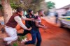 In this Monday, Sept. 2, 2019, photo, Nigerian foreign nationals remove a looter from their shops in Troyville, Johannesburg and take him to a waiting police van. Looting and violence spread across several neighbourhoods in South Africa's major cities of Pretoria and Johannesburg after a spate of attacks that appeared to target foreign-owned shops. (AP Photo)