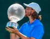 England's Tommy Fleetwood celebrates winning the the 39th edition of the Nedbank Golf Challenge, at Sun City, South Africa, Sunday, Nov. 17 2019. Fleetwood made three eagles and came from six shots behind going into the final round to win the Nedbank Golf Challenge in a playoff against Marcus Kinhult on Sunday. (AP Photo/Christiaan Kotze)