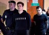 FILE - In this Wednesday, April 3, 2019 file photo, Zenit St. Petersburg striker Alexander Kokorin, second left, and Krasnodar's midfielder Pavel Mamayev arrive for a hearing in a court in Moscow, Russia. Alexander Kokorin and Pavel Mamayev were paroled four months after they were sentenced to prison for a string of drunken assaults last year and will be freed Sept. 17, 2019 if there is no appeal from prosecutors. (AP Photo/Dmitry Serebryakov, File)