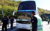 Serbian police officers guard a bus with Red Star players at the border crossing between Serbia and Kosovo, near the village of Rudnica, Serbia, Wednesday, Oct. 9, 2019. Kosovo authorities have banned a soccer match between Red Star Belgrade and a local Serb team and prevented their bus from crossing into the former Serbian province. (AP Photo/Bojan Slavkovic)