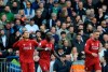 Liverpool's Roberto Firmino, left, celebrates with teammates after scoring his side's opening goal during the English Premier League soccer match between Liverpool and Tottenham Hotspur at Anfield stadium in Liverpool, England, Sunday, March 31, 2019. (AP Photo/Rui Vieira)