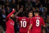 Liverpool's Mohamed Salah, left, celebrates with teammates after scoring his side's second goal during the Champions League quarterfinals, 2nd leg, soccer match between FC Porto and Liverpool at the Dragao stadium in Porto, Portugal, Wednesday, April 17, 2019. (AP Photo/Luis Vieira)