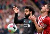 Liverpool's Mohamed Salah, left, duels for the ball with Sheffield United's Enda Stevens during the English Premier League soccer match between Sheffield United and Liverpool at Bramall Lane in Sheffield, England, Saturday, Sept. 28, 2019. (AP Photo/Rui Vieira)