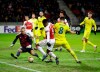 Bate goalkeeper Denis Scherbitski, left, makes a save in front of Arsenal's Alexandre Lacazette, front left, during the Europa League round of 32 first leg soccer match between Bate and Arsenal at the Borisov-Arena in Borisov, Belarus, Thursday, Feb. 14, 2019. (AP Photo/Sergei Grits)