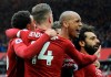 Liverpool's Mohamed Salah, right, celebrates with teammates after scoring his side's second goal during the English Premier League soccer match between Liverpool and Chelsea at Anfield stadium in Liverpool, England, Sunday, April 14, 2019. (AP Photo/Rui Vieira)