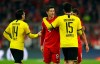 Bayern's Robert Lewandowski, center, hugs with Dortmund's Mats Hummels, right, at the end of the German Bundesliga soccer match between FC Bayern Munich and Borussia Dortmund, in Munich, Germany, Saturday, Nov. 9, 2019. (AP Photo/Matthias Schrader)
