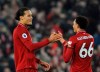 Liverpool's Virgil van Dijk, left, celebrates with Liverpool's Trent Alexander-Arnold at the end of the English Premier League soccer match between Liverpool and Watford at Anfield stadium in Liverpool, England, Wednesday, Feb. 27, 2019. (AP Photo/Rui Vieira)