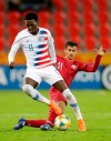 United States' Tim Weah, front, duels for the ball with Qatar's Abdulla Nasser during the Group D U20 World Cup soccer match between USA and Qatar, in Tychy, Poland, Thursday, May 30, 2019. (AP Photo/Sergei Grits)